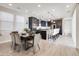 Bright kitchen and dining area with a central island, modern lighting, and stylish furniture at 2412 W Gloria Ln, Phoenix, AZ 85085