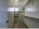 Spacious walk-in closet with ample shelving and carpet flooring, offering plenty of storage space at 2412 W Gloria Ln, Phoenix, AZ 85085