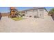 Spacious backyard featuring a playset and stone landscaping at 29481 W Mitchell Ave, Buckeye, AZ 85396