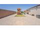 Backyard with a playset, gravel landscaping, and privacy wall at 29481 W Mitchell Ave, Buckeye, AZ 85396