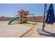 A great backyard featuring a play structure, paved patio, and an umbrella for shade at 29481 W Mitchell Ave, Buckeye, AZ 85396