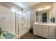 Bathroom with a glass shower, white vanity, and tiled floors at 29481 W Mitchell Ave, Buckeye, AZ 85396
