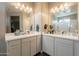 Dual sink bathroom vanity with quartz countertop, lighting and large mirror at 29481 W Mitchell Ave, Buckeye, AZ 85396