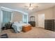 Bedroom with a ceiling fan, carpet floors, a queen bed, nightstands, dressers and light blue curtains at 29481 W Mitchell Ave, Buckeye, AZ 85396