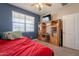 Bedroom with media center, window for natural light and a ceiling fan at 29481 W Mitchell Ave, Buckeye, AZ 85396
