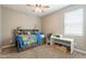 Bedroom featuring a ceiling fan, a window with blinds, a bed with built-in shelves, and carpet floors at 29481 W Mitchell Ave, Buckeye, AZ 85396