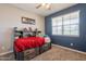 Bedroom with a blue wall and built-in shelving for storage and display at 29481 W Mitchell Ave, Buckeye, AZ 85396