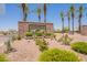 Entrance to Tartesso community with lush landscaping and palm trees at 29481 W Mitchell Ave, Buckeye, AZ 85396