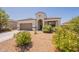 Inviting home with desert landscaping, a two-car garage, and a welcoming entrance adorned with plants at 29481 W Mitchell Ave, Buckeye, AZ 85396