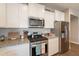 Close up on updated kitchen featuring stainless steel appliances and granite countertops at 29481 W Mitchell Ave, Buckeye, AZ 85396