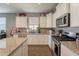 Beautiful kitchen boasts granite countertops, stainless steel appliances, and bright cabinets at 29481 W Mitchell Ave, Buckeye, AZ 85396