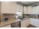 Well-lit kitchen featuring a stainless steel dishwasher and a view from the window at 29481 W Mitchell Ave, Buckeye, AZ 85396