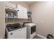 Laundry room with modern appliances, upper cabinets, and plenty of space at 29481 W Mitchell Ave, Buckeye, AZ 85396