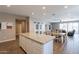 Spacious open floor plan with a large island, dining area, and sliding barn doors at 29481 W Mitchell Ave, Buckeye, AZ 85396