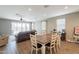 An open concept living area with dining table and sliding glass doors to backyard at 29481 W Mitchell Ave, Buckeye, AZ 85396