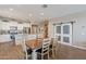 Open concept kitchen, dining area, and living room with modern finishes and bright lighting at 29481 W Mitchell Ave, Buckeye, AZ 85396