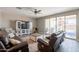 Inviting living room featuring a view to the backyard, ceiling fan, and a large media console at 29481 W Mitchell Ave, Buckeye, AZ 85396