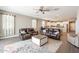 Bright living room adjoining the kitchen, furnished with a ceiling fan and comfortable leather sofas at 29481 W Mitchell Ave, Buckeye, AZ 85396