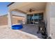Covered patio area with patio furniture, grill, and backyard access at 29481 W Mitchell Ave, Buckeye, AZ 85396