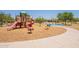 Community playground with multiple slides, spring riders, and wood chip groundcover at 29481 W Mitchell Ave, Buckeye, AZ 85396