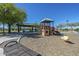 Community playground nestled between a covered picnic area, playset and spring rider, promoting outdoor play at 29481 W Mitchell Ave, Buckeye, AZ 85396