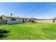 This large grassy back yard features a covered patio and block fencing at 3050 E Cholla E St, Phoenix, AZ 85028