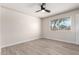 Bright bedroom with a large window offering natural light, wood-look floors, and neutral tones at 3050 E Cholla E St, Phoenix, AZ 85028