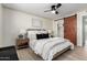 Well-lit bedroom featuring wood-look floors, a modern ceiling fan, and a barn door closet in a neutral decor at 3050 E Cholla E St, Phoenix, AZ 85028