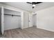 This bedroom features a spacious closet, wood-look tile floors and a modern ceiling fan at 3050 E Cholla E St, Phoenix, AZ 85028