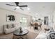 Open-concept living area with sleek ceiling fan flowing into a kitchen with modern cabinetry and stainless appliances at 3050 E Cholla E St, Phoenix, AZ 85028