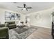 Cozy living area featuring a large area rug, neutral wall color, and ceiling fan at 3050 E Cholla E St, Phoenix, AZ 85028