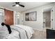 A sunlit main bedroom features an en-suite bathroom and a barn door closet offering both style and functionality at 3050 E Cholla E St, Phoenix, AZ 85028