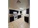 Updated kitchen featuring sleek black cabinetry and modern white appliances at 3328 E Crescent Ave, Mesa, AZ 85204
