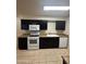 Well-equipped kitchen with a sleek white appliances and dark cabinetry at 3328 E Crescent Ave, Mesa, AZ 85204