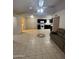 Open-concept design with ceramic flooring connecting the living room and kitchen areas at 3328 E Crescent Ave, Mesa, AZ 85204