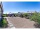 Landscaped backyard featuring a charming pergola, lush greenery, and a serene atmosphere at 36076 W Santa Barbara Ave, Maricopa, AZ 85138