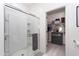 Modern bathroom features a glass-enclosed shower and an organized closet at 36076 W Santa Barbara Ave, Maricopa, AZ 85138
