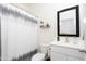 Neat bathroom with modern fixtures, including a vanity with storage and a decorative shower curtain at 36076 W Santa Barbara Ave, Maricopa, AZ 85138
