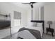 Cozy bedroom with a dark gray accent wall, a queen-size bed and a decorative bedside lamp at 36076 W Santa Barbara Ave, Maricopa, AZ 85138