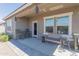 Relaxing covered patio with comfortable seating, stylish decor, and easy access to the backyard at 36076 W Santa Barbara Ave, Maricopa, AZ 85138