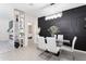 Modern dining area with a sleek glass table, chic white chairs and a contemporary chandelier at 36076 W Santa Barbara Ave, Maricopa, AZ 85138