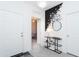 Bright foyer featuring a modern chandelier, decorative wall art and access to a room with natural light at 36076 W Santa Barbara Ave, Maricopa, AZ 85138
