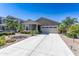 Charming single-story home with desert landscaping, a neutral color and a spacious two car garage at 36076 W Santa Barbara Ave, Maricopa, AZ 85138