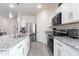 Well-appointed kitchen boasts granite counters, stainless steel appliances, and ample storage space at 36076 W Santa Barbara Ave, Maricopa, AZ 85138