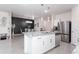 Open-concept kitchen showcases granite counters, stainless appliances, and adjacent dining area at 36076 W Santa Barbara Ave, Maricopa, AZ 85138