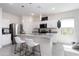 Bright kitchen features granite counters, stainless steel appliances, and a modern island at 36076 W Santa Barbara Ave, Maricopa, AZ 85138