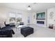 Cozy living room with fireplace, stylish decor, and sliding glass doors to the patio at 36076 W Santa Barbara Ave, Maricopa, AZ 85138