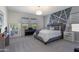 Serene primary bedroom with designer wall, plush carpet, and lots of natural light at 36076 W Santa Barbara Ave, Maricopa, AZ 85138