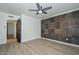Bright bedroom with striking accent wall, modern fan, and wood look tile at 3637 E Monterosa St # 8, Phoenix, AZ 85018