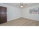Bright bedroom features wood-look flooring, ceiling fan, and window overlooking mature landscaping at 3637 E Monterosa St # 8, Phoenix, AZ 85018